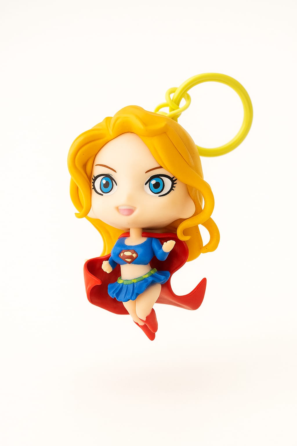 Supergirl figurine keychain on a white background